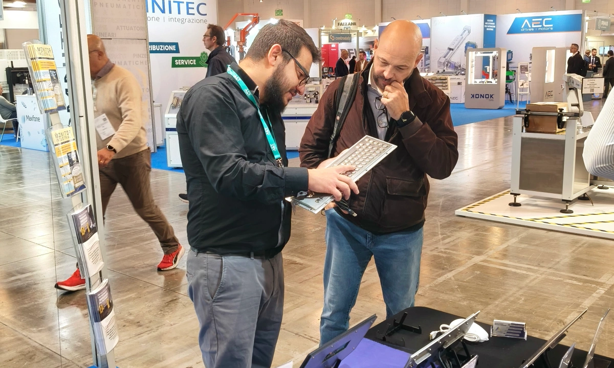 DAVOLIN demonstrating industrial keyboard to client at manufacturing exhibition in Monterrey Mexico