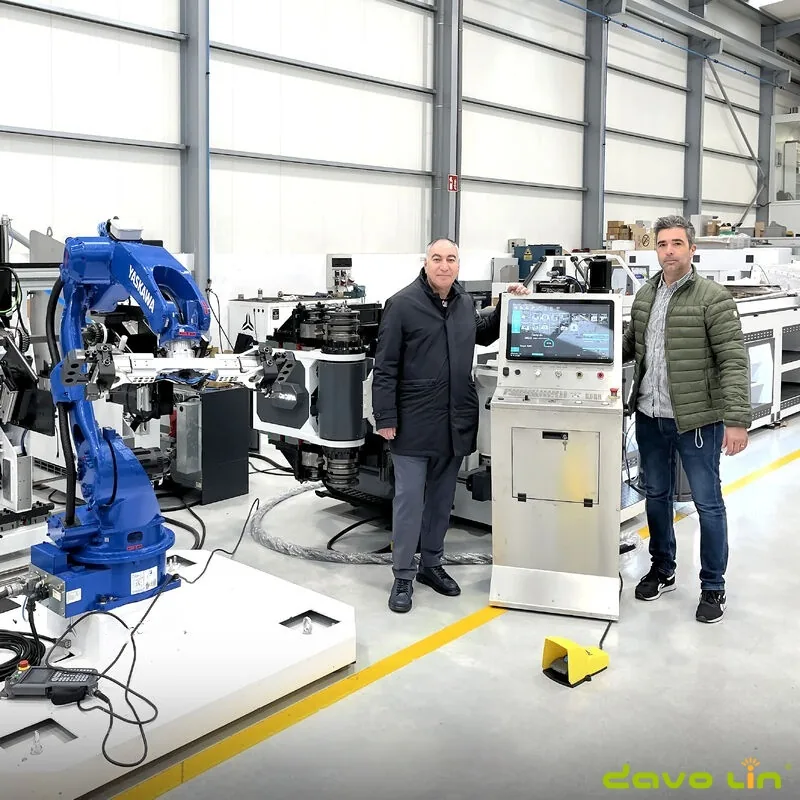 Engineering team beside a completed CNC tube bending machine