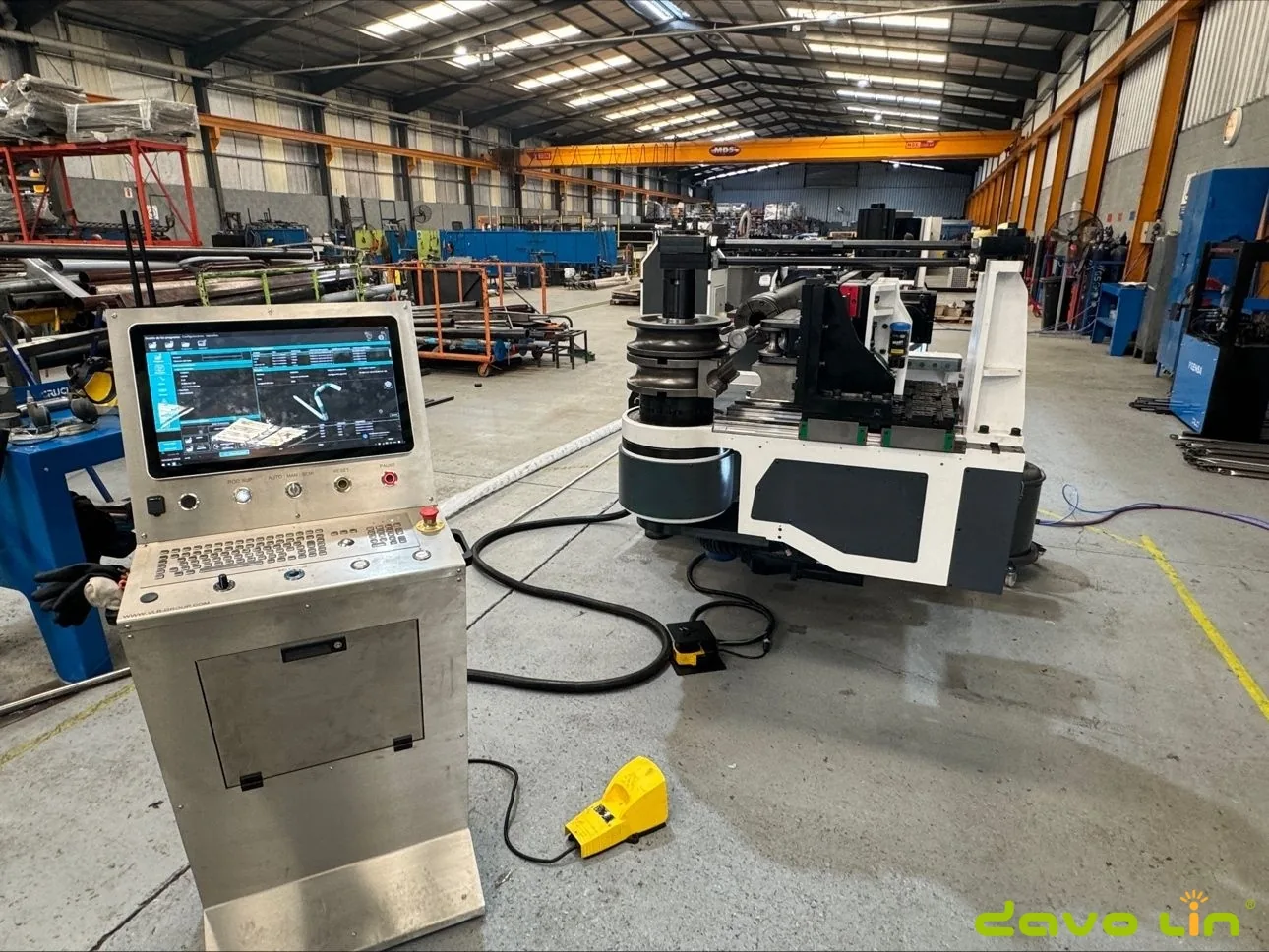 CNC tube bending equipment operating in an industrial manufacturing workshop
